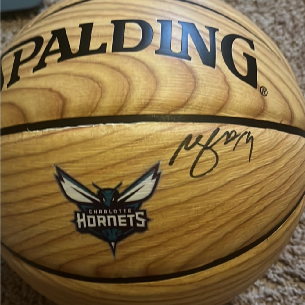 Former  Charlotte Hornets forward Michael Kidd Gilchrest signed basketball